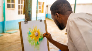 Students of ICAST School, Ibadan doing art work on an easel