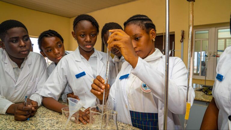 Students at ICAST School, Ibadan having a chemistry experiment